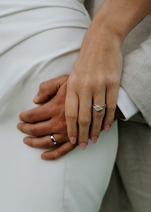 Close-up series of hands with wedding rings resting on white fabric.