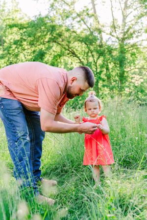 Two people sharing a tender moment in a lush green field during spring.