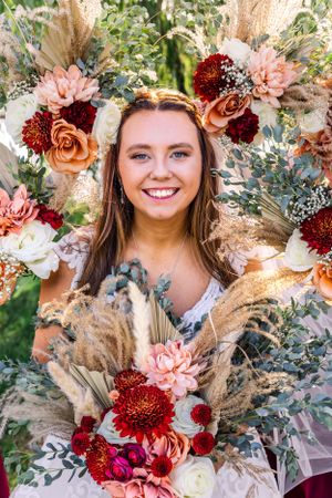 Beautiful floral arrangement with red and pink flowers mixed with pampas grass.
