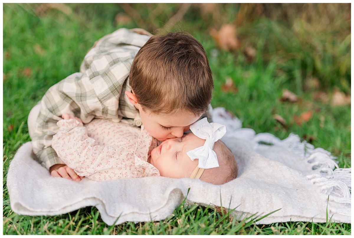 Sweet candid brother kissing baby sister photo by Indianapolis family photographer Jayme Riggleman Photography