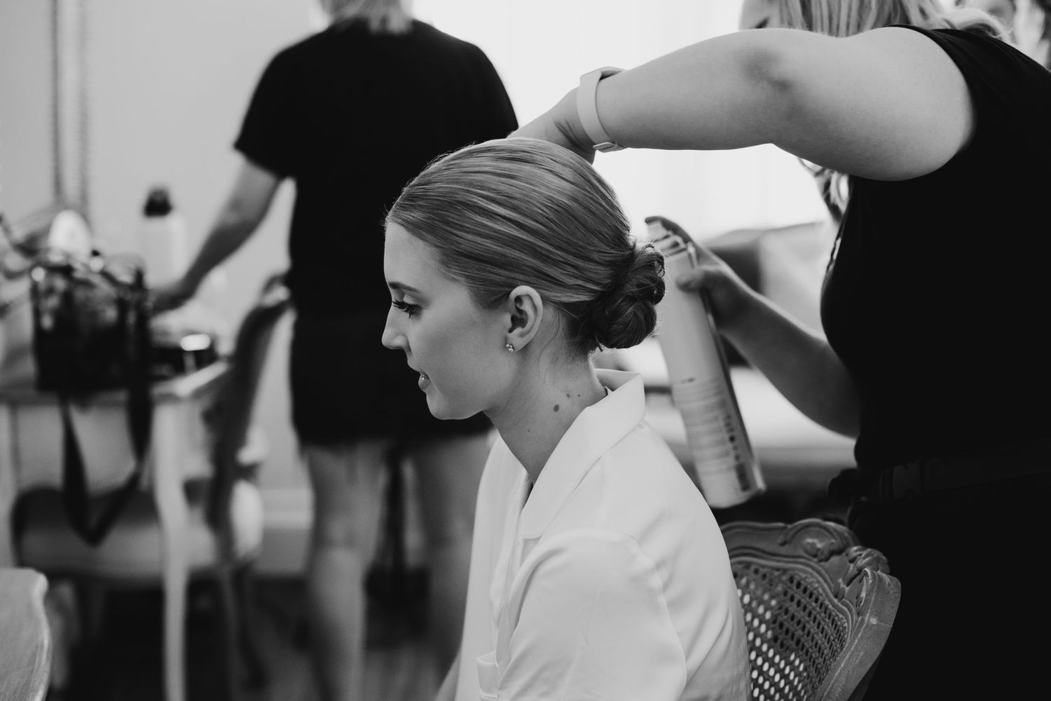 Black and white image showing wedding day preparation moments.