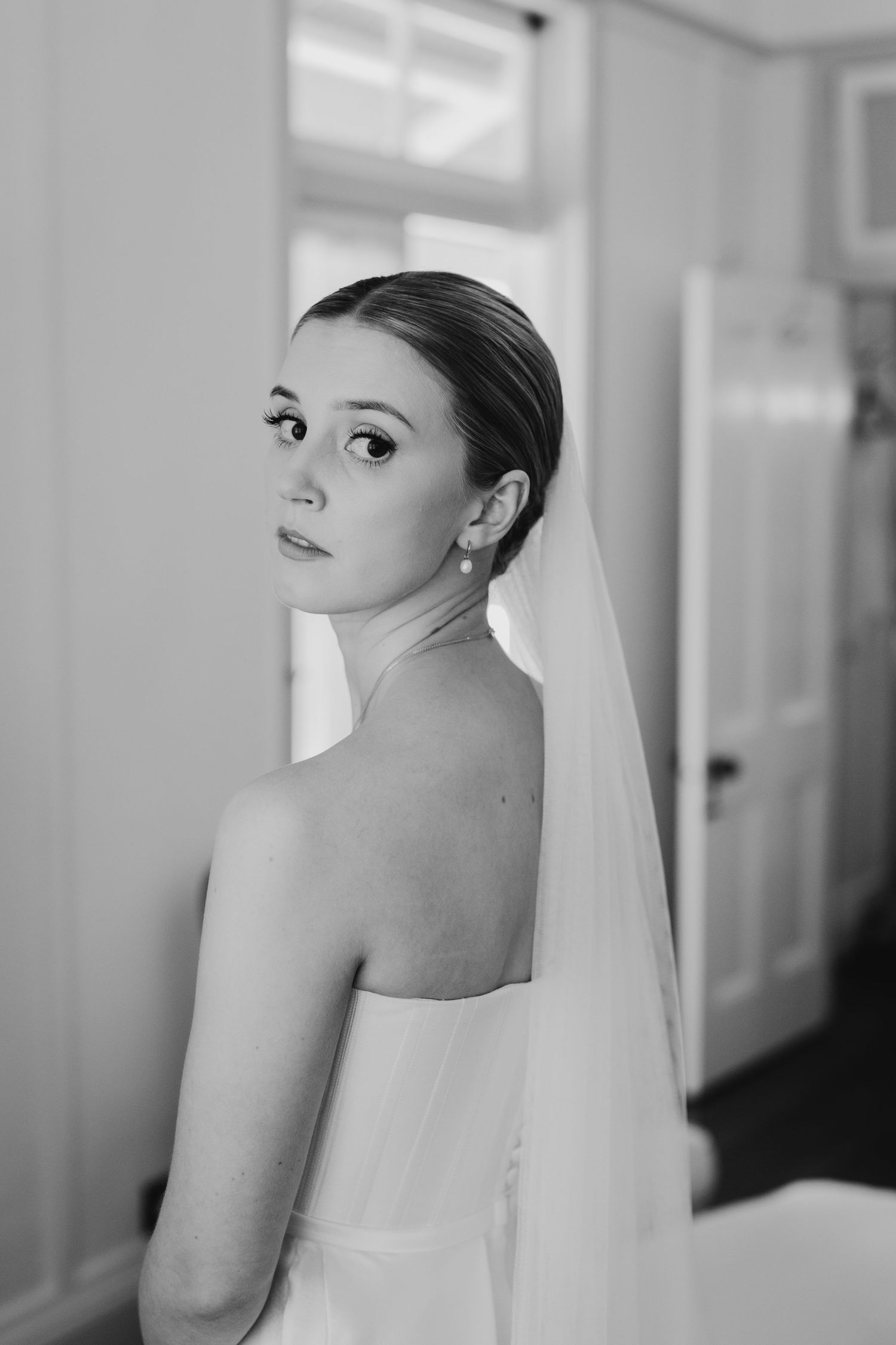 Black and white portrait series showing elegant bridal details and veil in soft natural light.