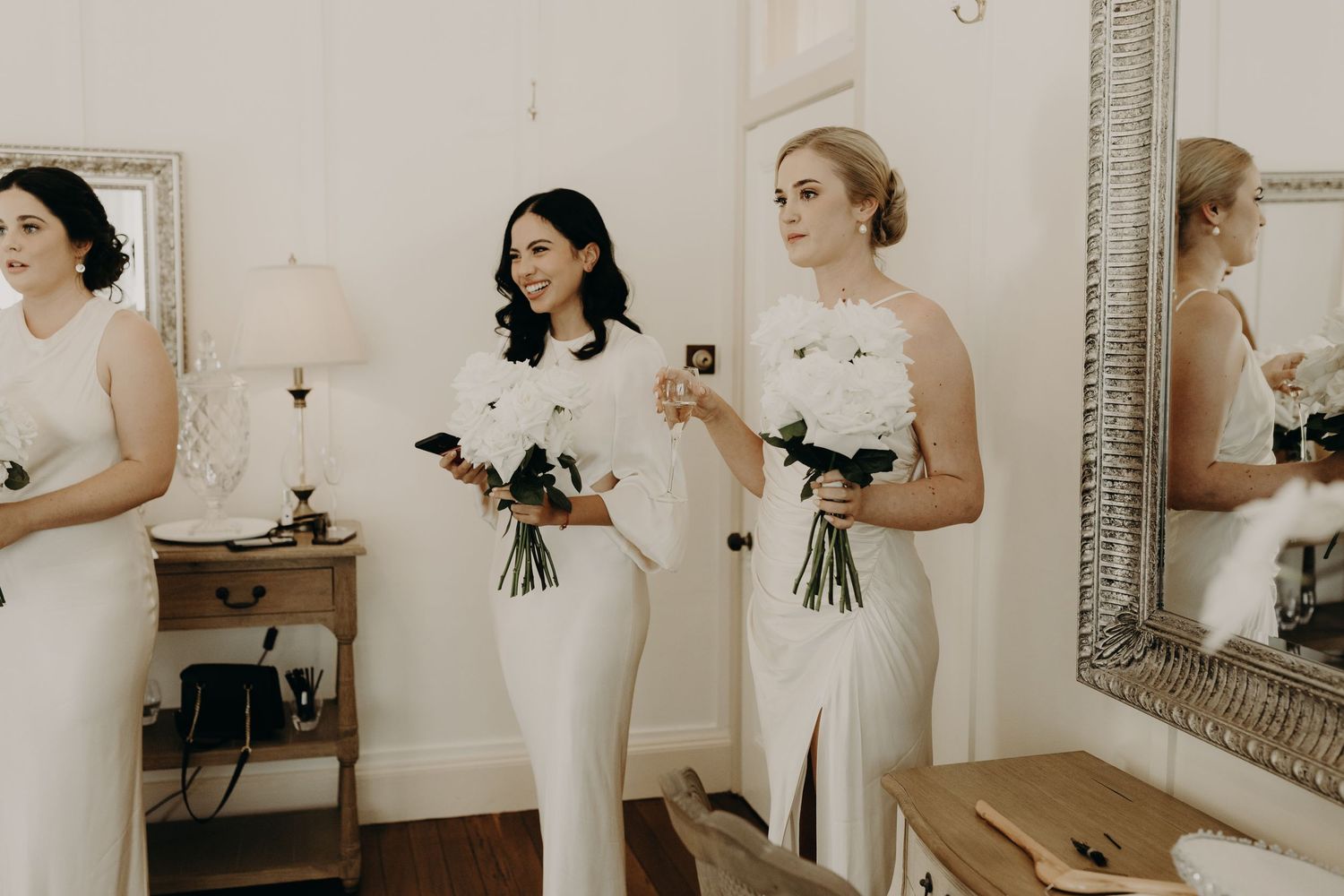 Bridal party getting ready sequence with elegant white dresses and bouquets.