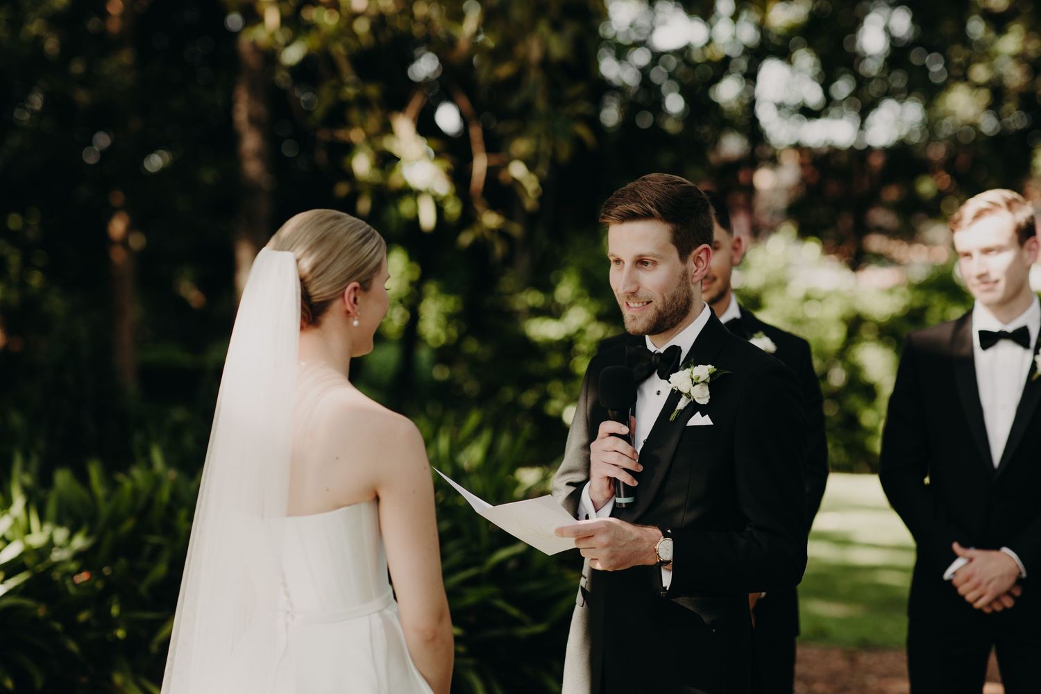 Intimate wedding ceremony moments captured under natural garden lighting.