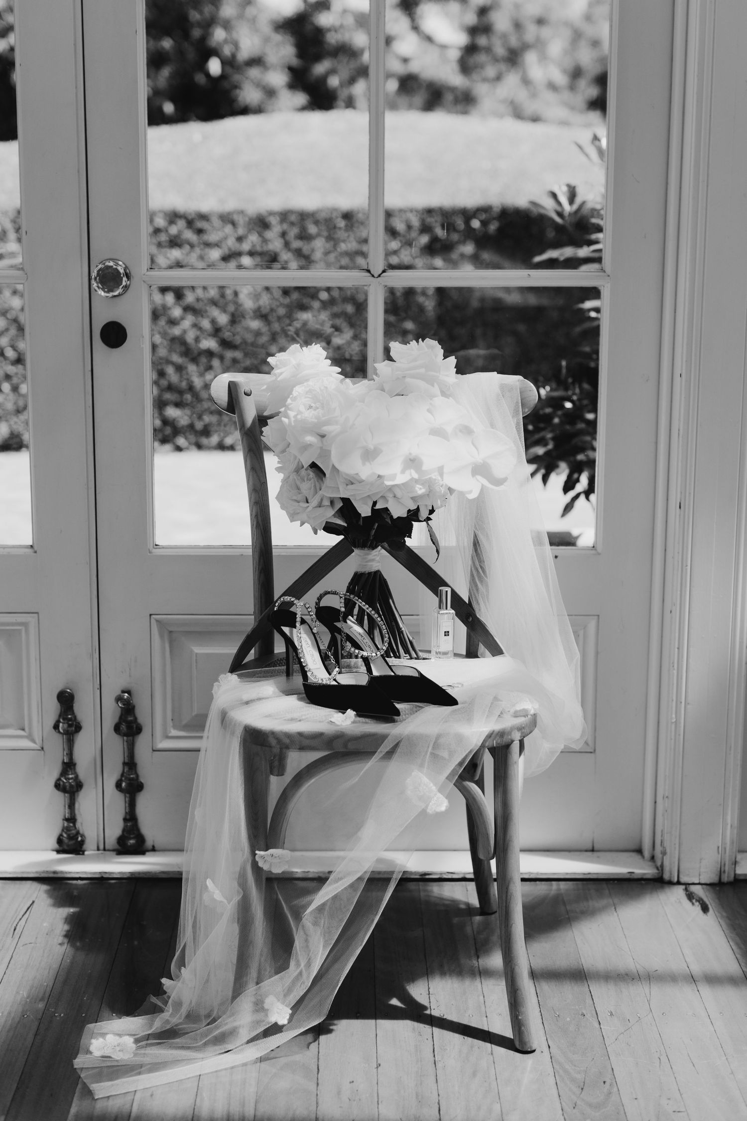 Black and white artistic photos of a flowing white wedding dress in natural light.