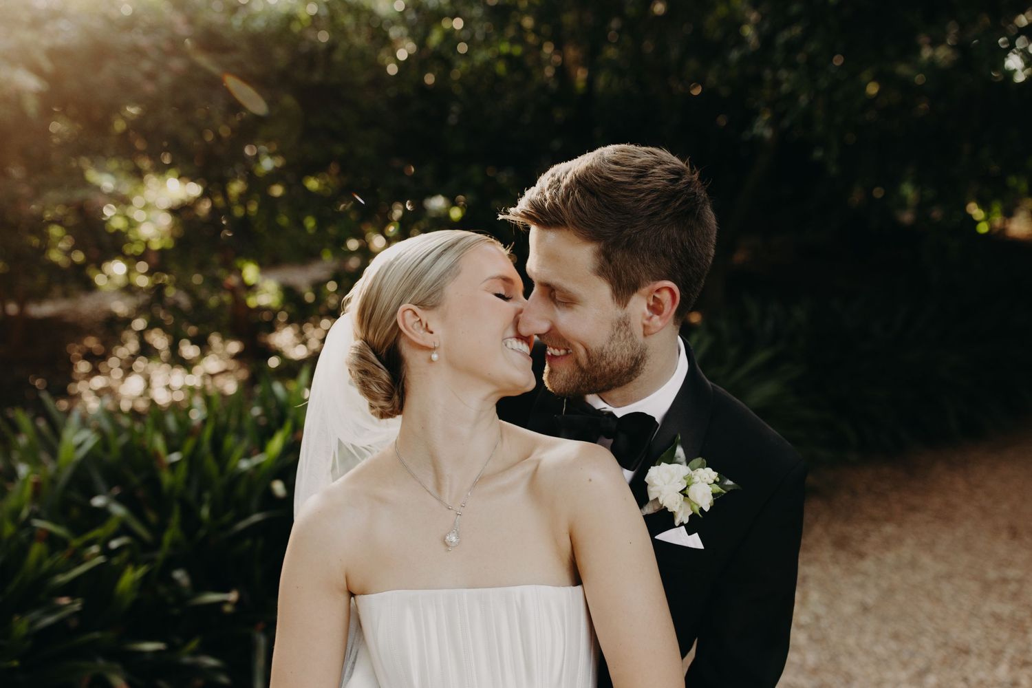 A romantic wedding moment captured during an outdoor garden photoshoot.