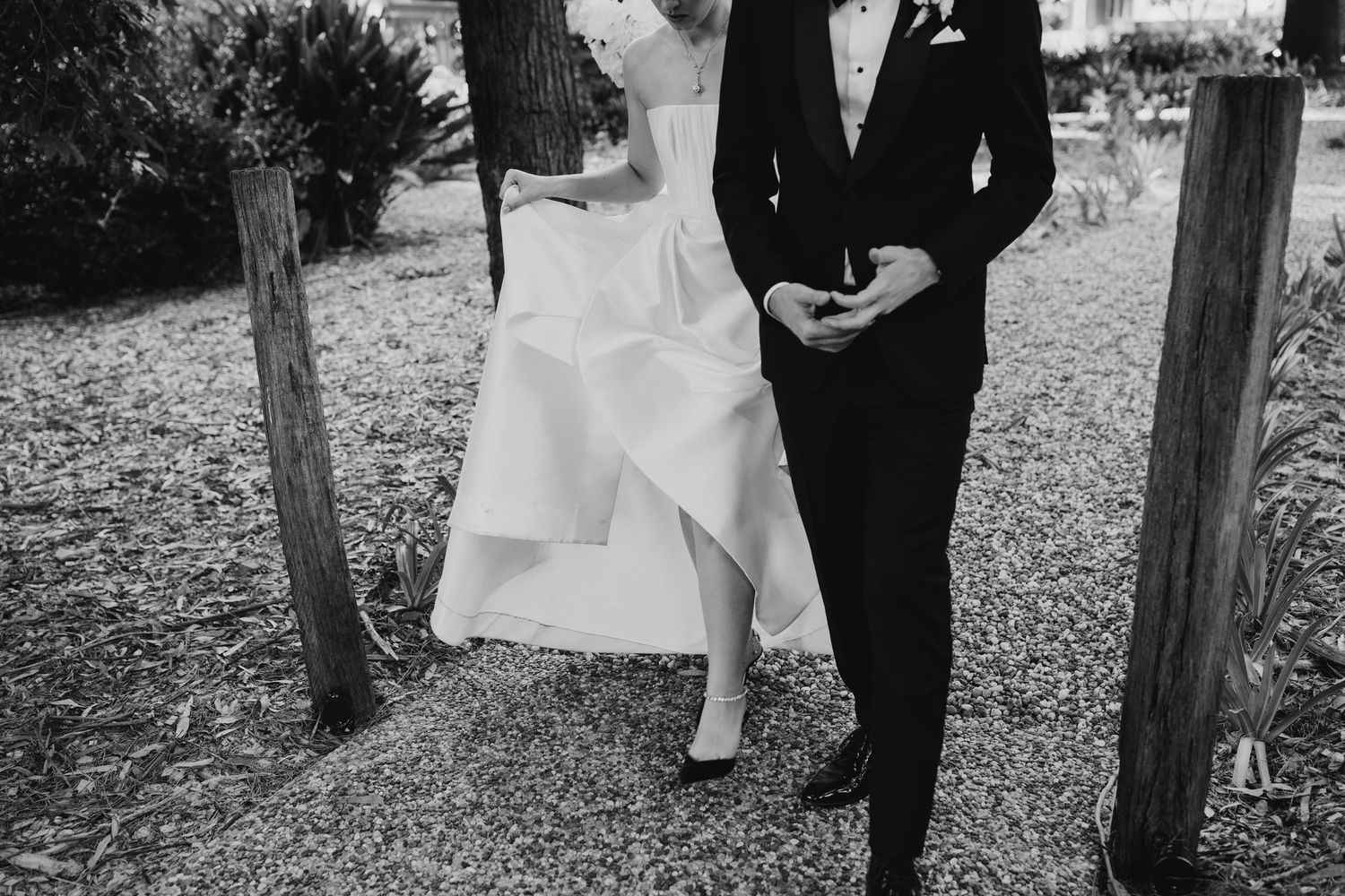 Black and white wedding photos capture intimate moments between newlyweds in a garden setting.