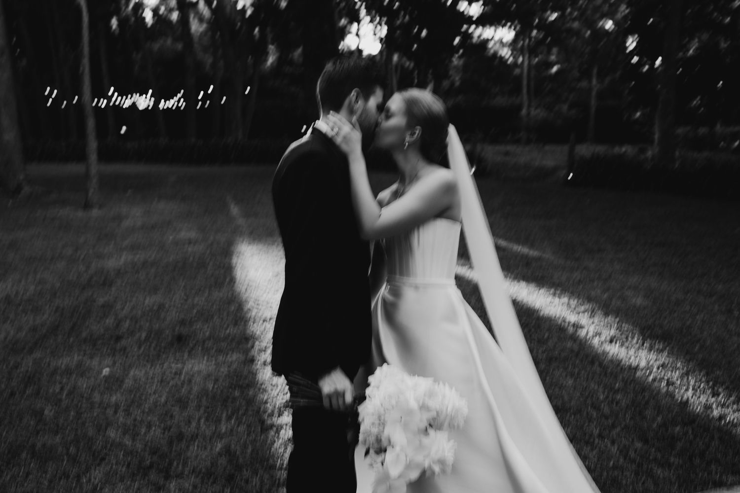 Artistic black and white wedding photography sequence showing romantic moments outdoors.