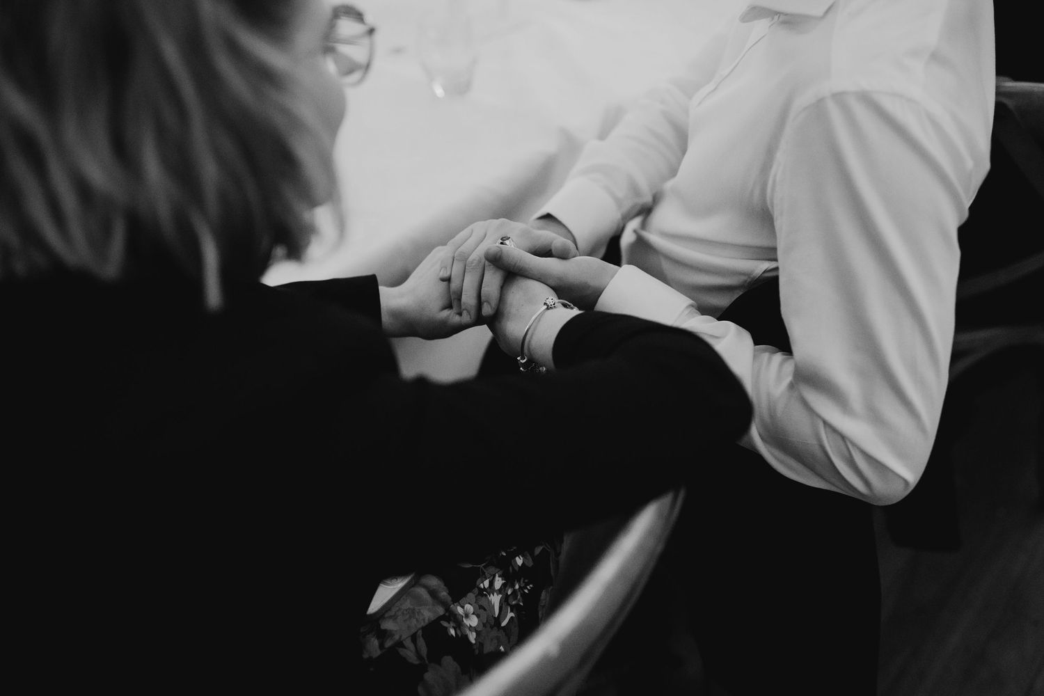 A couple dancing together in a dimly lit venue during a romantic celebration.