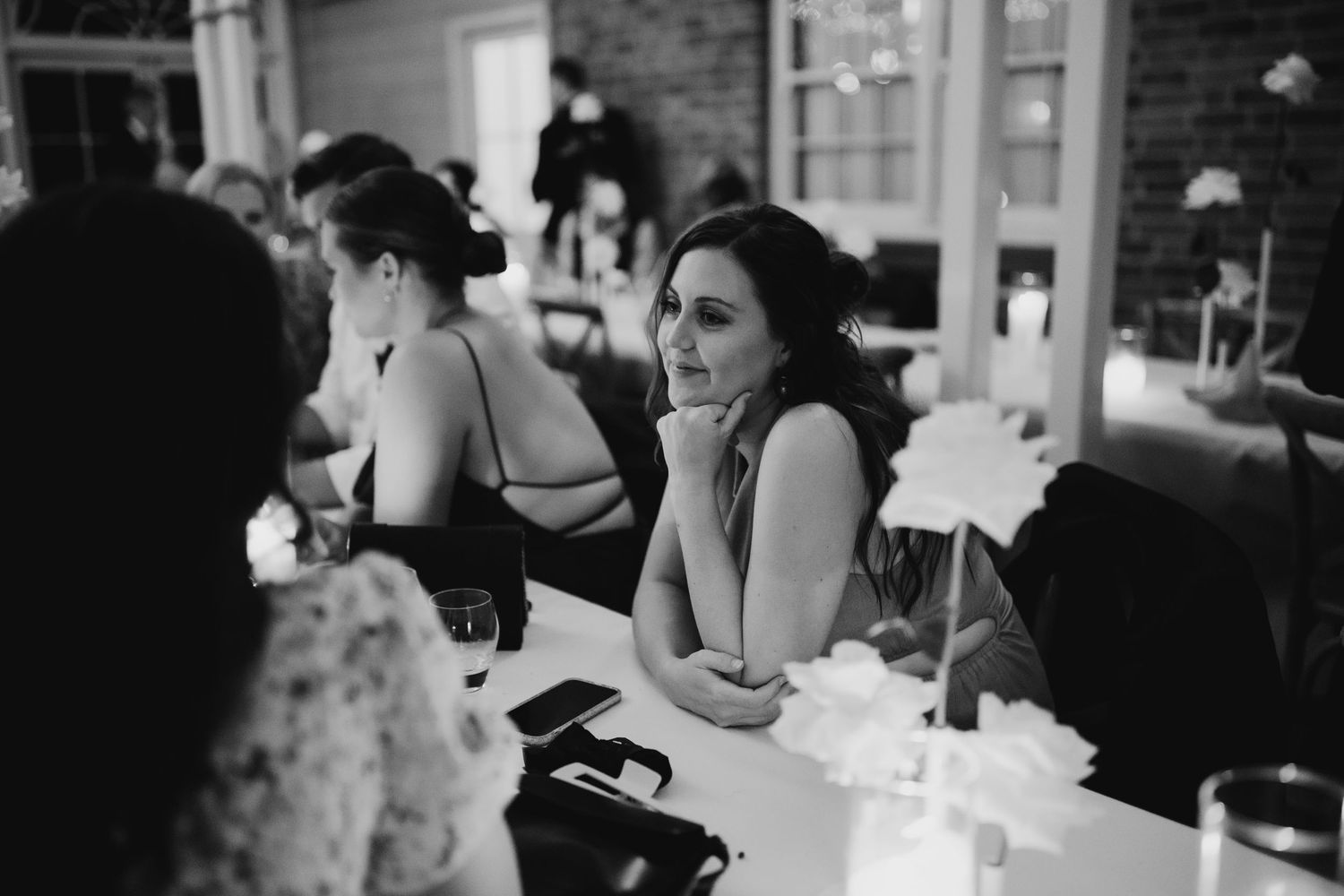 Black and white photo of wedding preparations with people getting ready.