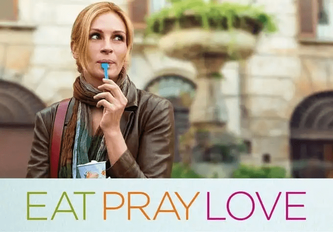 Movie title treatment for Eat Pray Love in green, orange and pink letters.