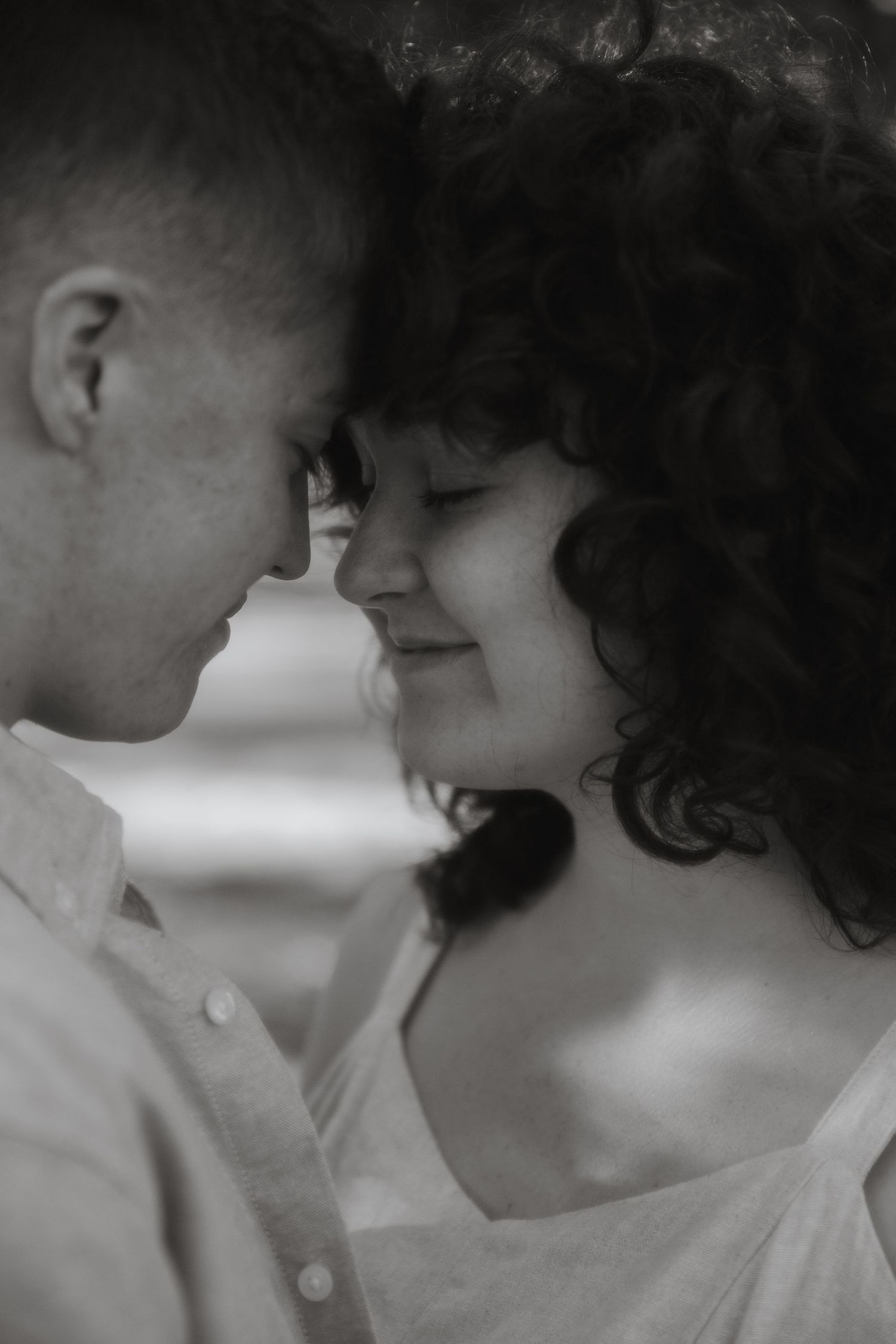 Couple with their foreheads resting on each other during a couples portrait session in Wilmington, NC.