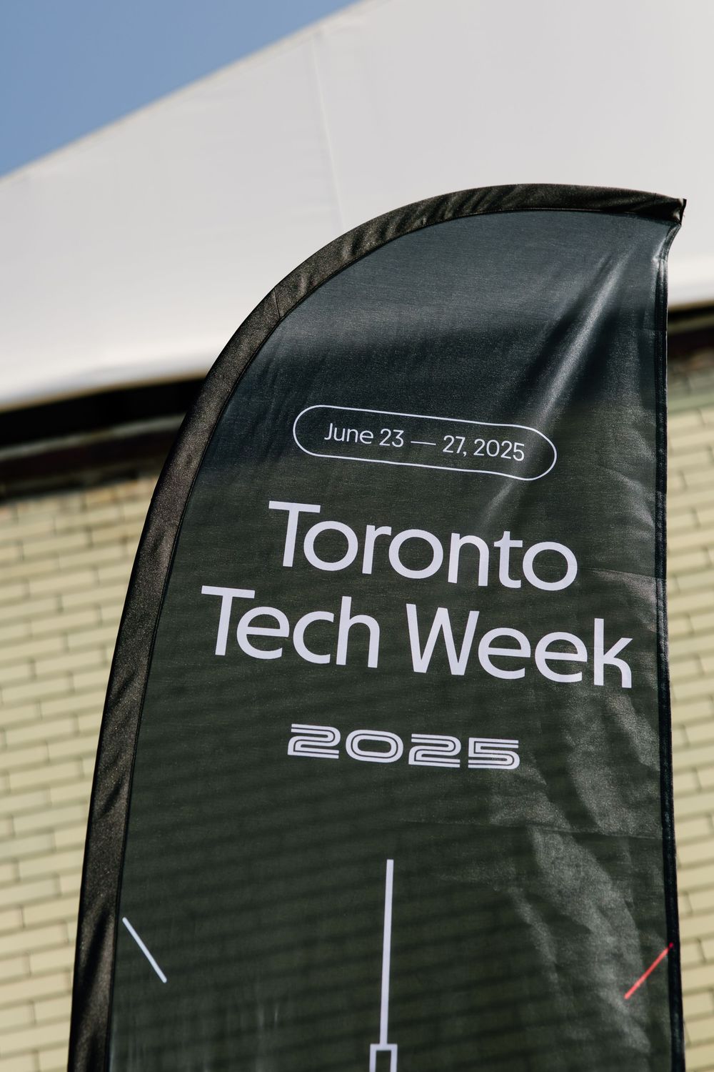 Black banners displaying 'Toronto Tech Week 2025' branding against a light colored wall.
