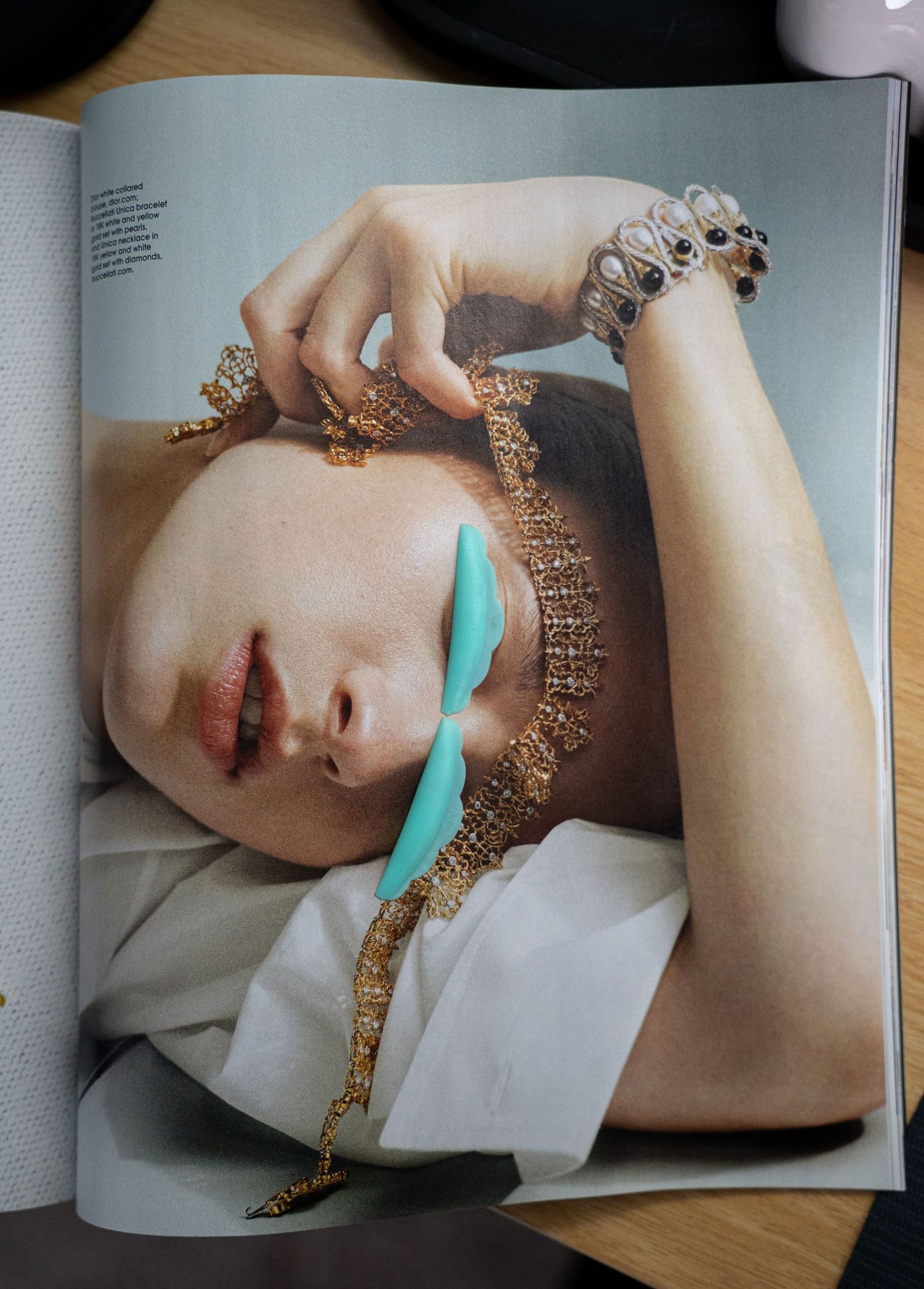 Magazine page featuring editorial jewelry photography with turquoise styling elements.