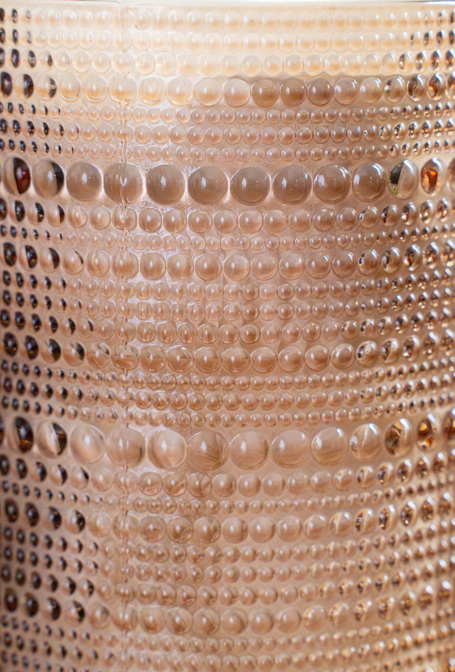 Close-up texture of peach-colored bubbles or dots arranged in a repeating pattern.