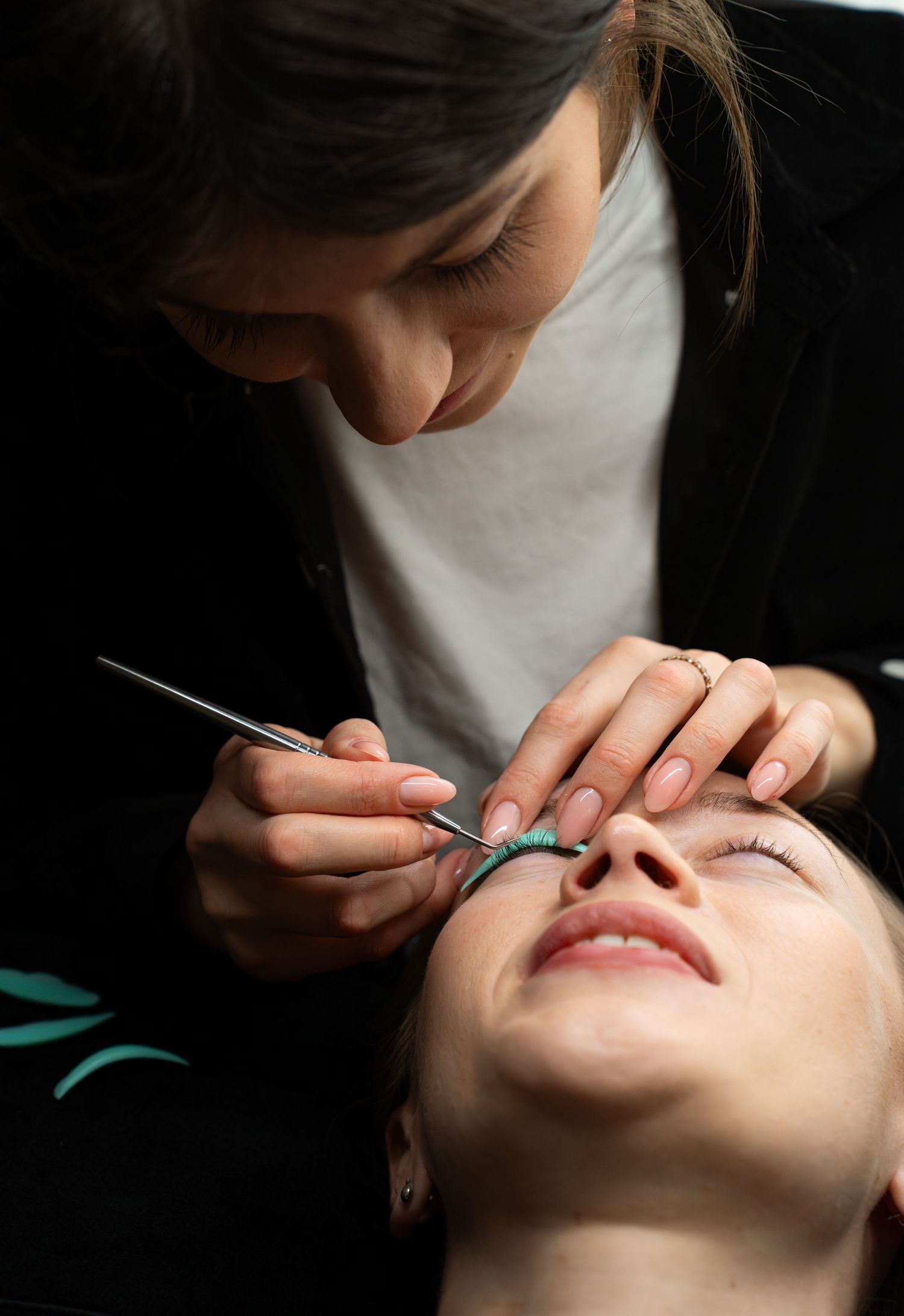 Professional beauty treatment being performed with precise detail work.