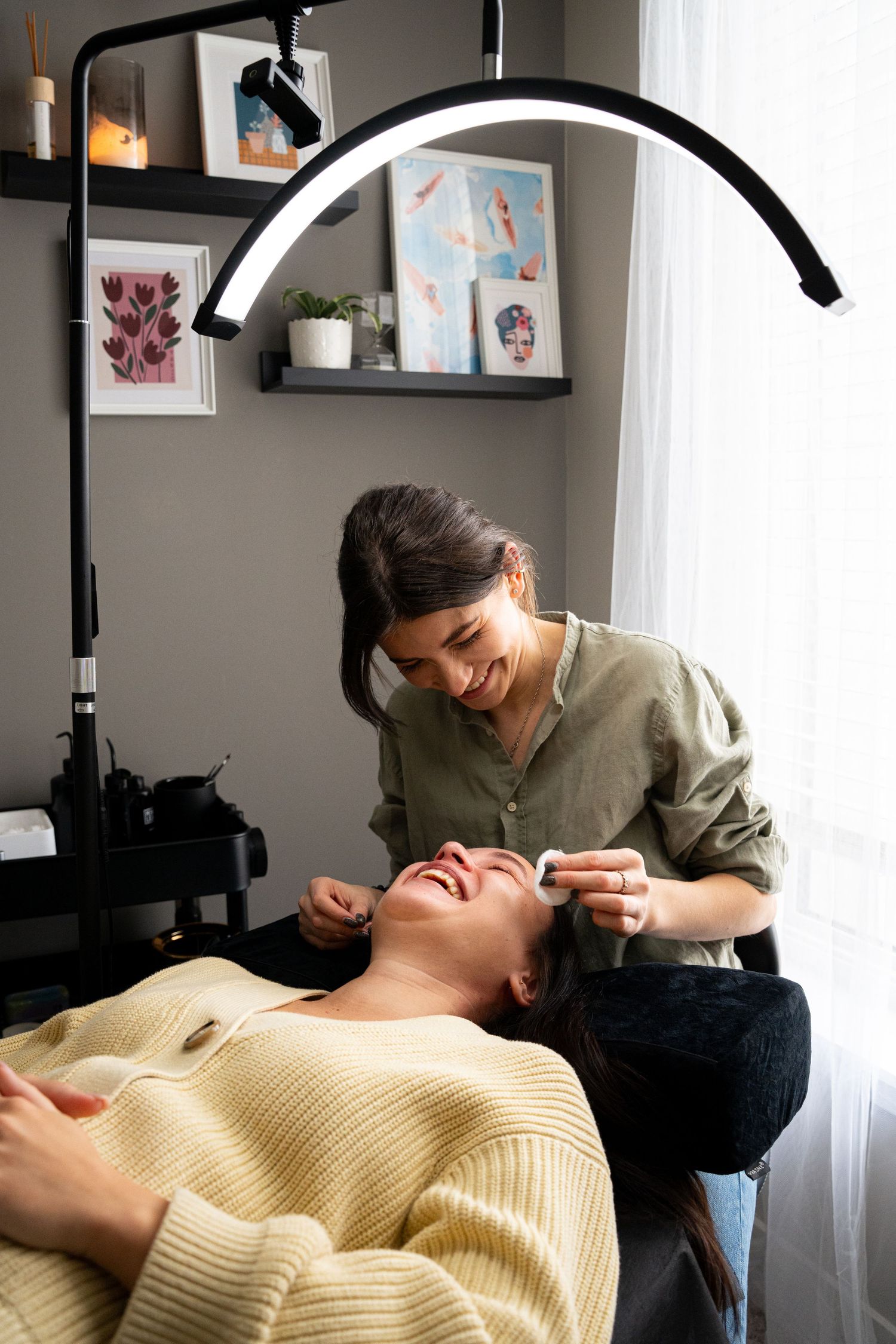 Beauty treatment session taking place in a salon with professional lighting equipment.