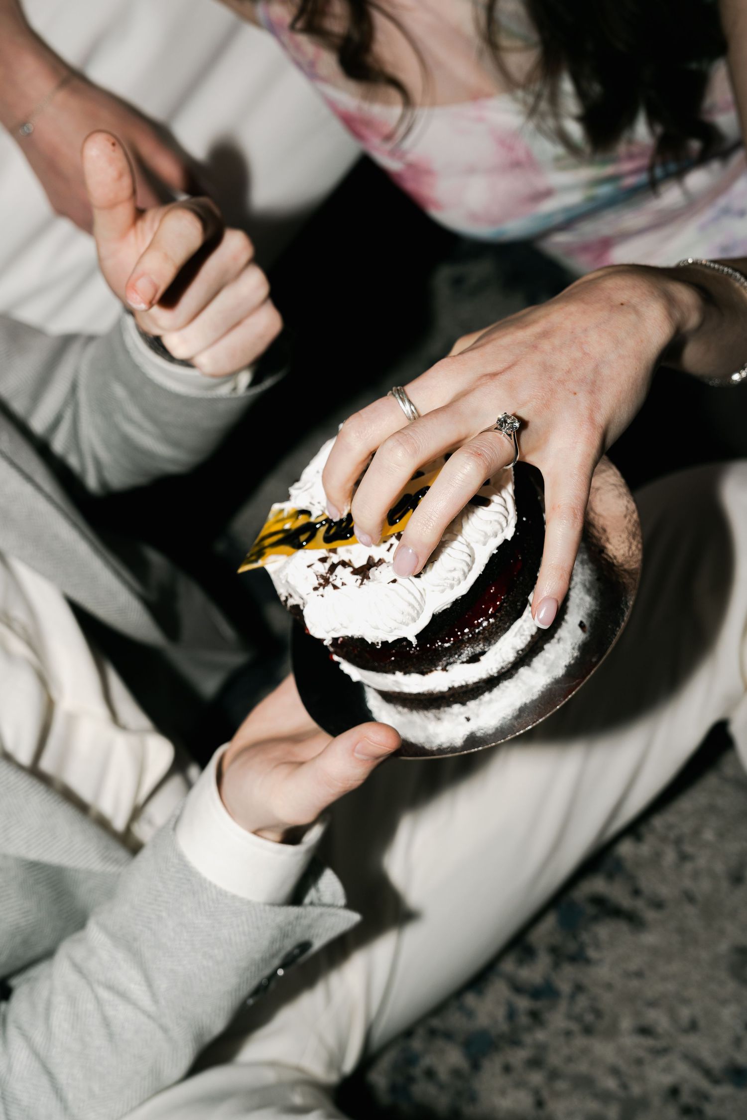 Direct flash creative cake feeding engagement in hotel room glamour vibe for pre- wedding photoshoot