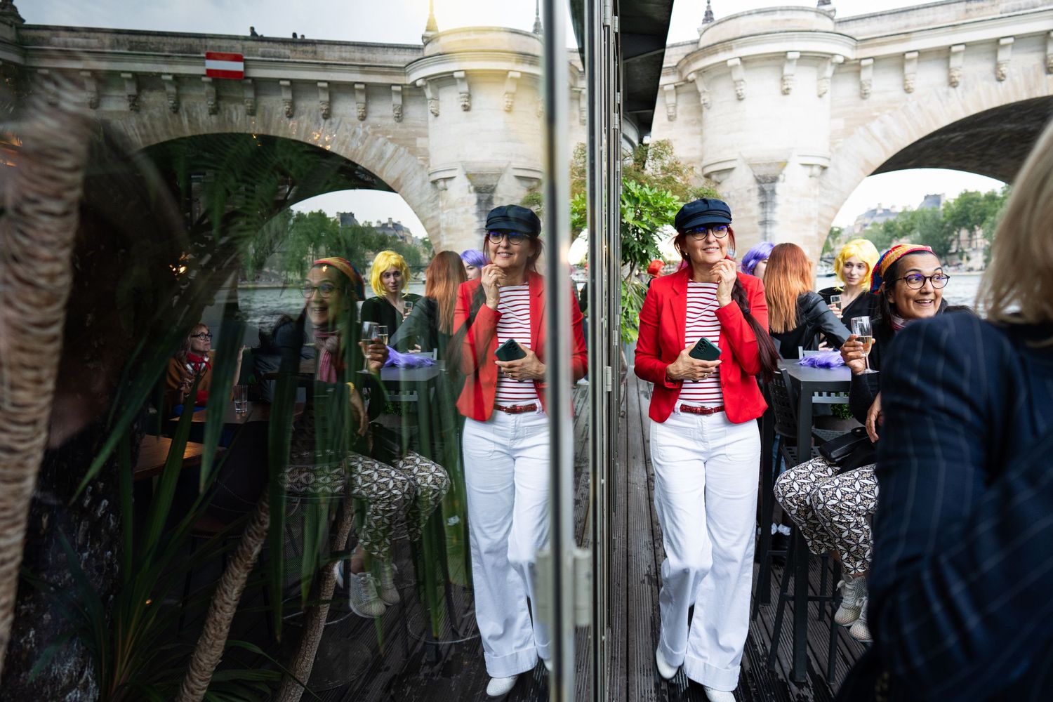 Traditional toy soldiers in red and white uniforms stand on display with reflections visible at a window in Bath, England.