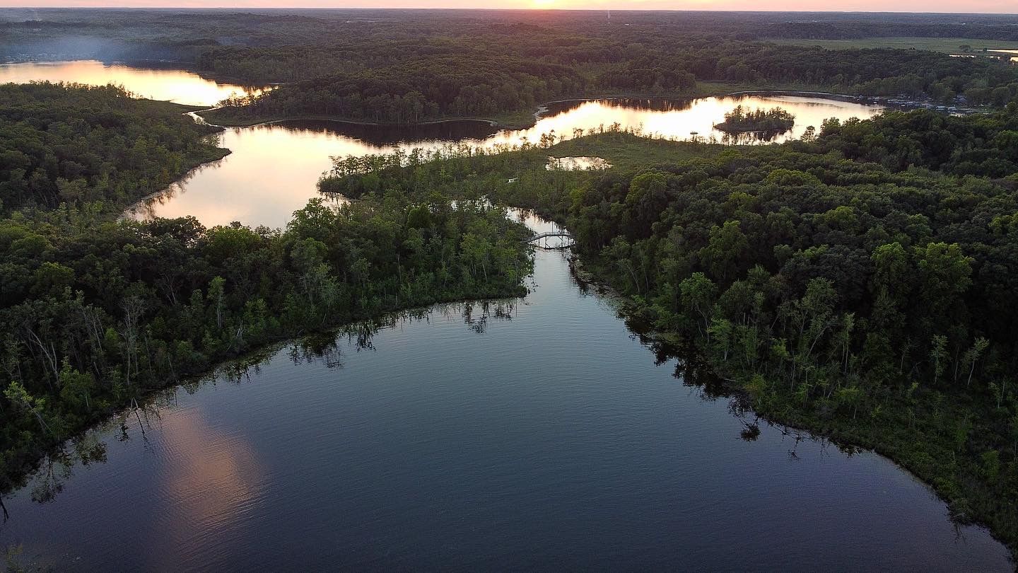 A lake with a sunset in its reflection