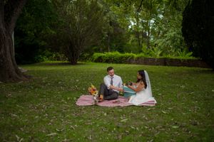 Bride and groom, pour champagne at small picnic on wedding day