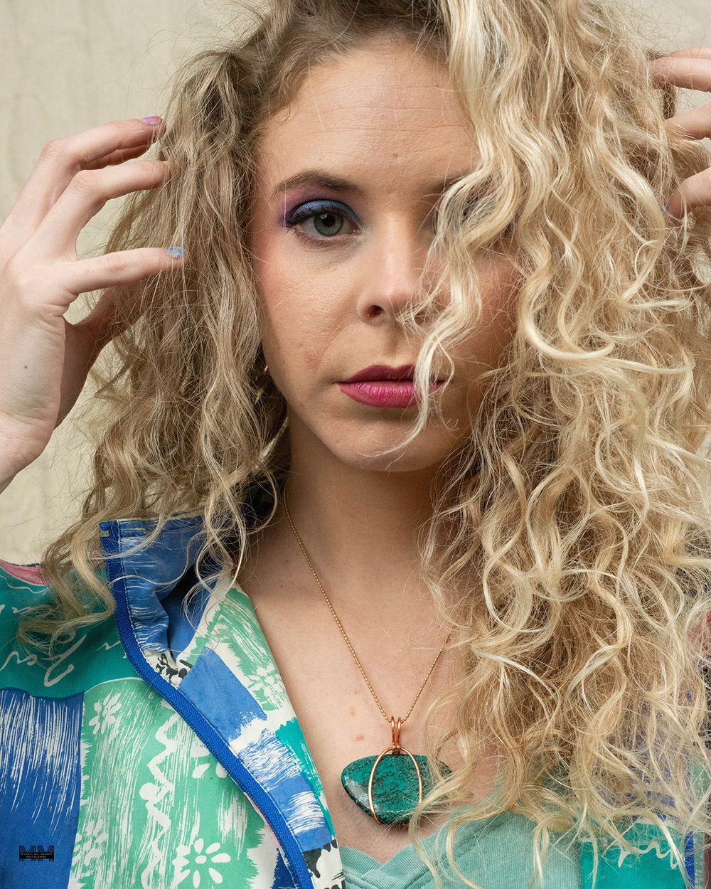 A series of four photos showing blonde curly hair and a green patterned top with bright red lipstick.