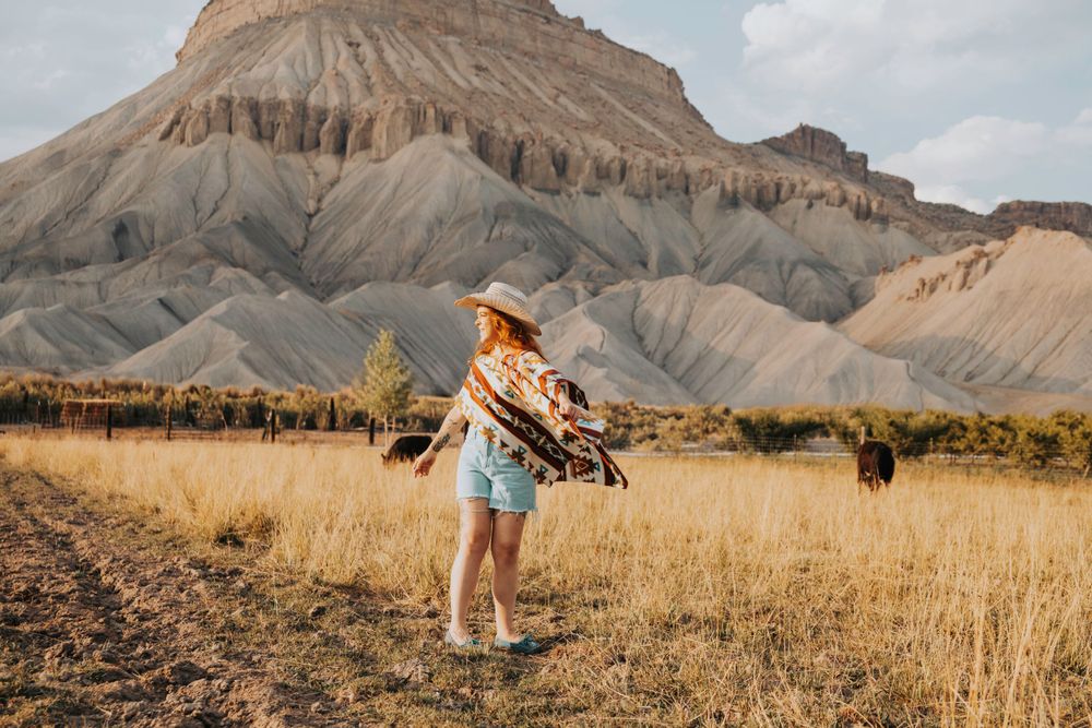 Western-themed photo shoot with mountain backdrop and desert landscape.