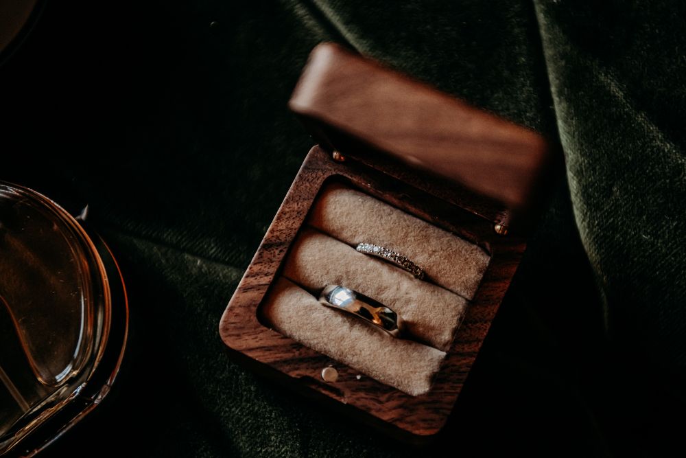 A sequence of photos showing a wooden box being opened to reveal a ring inside on a dark background.