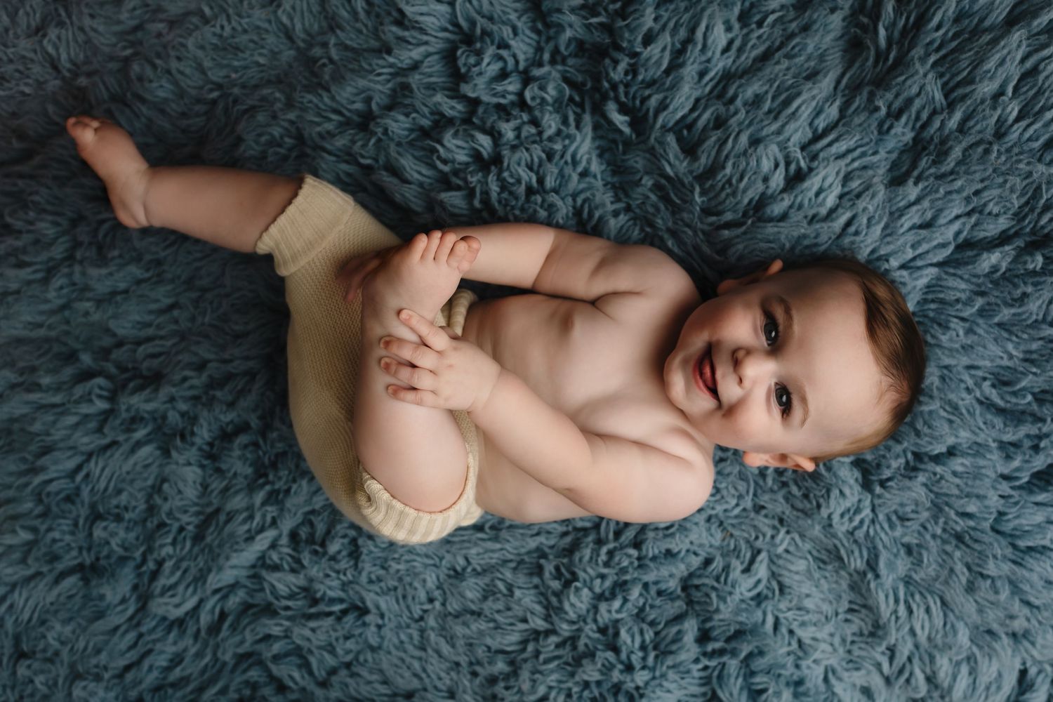 Charlottesville photographer, baby, milestone, maternity, newborn, family, happy baby boy laughing against blue flokati