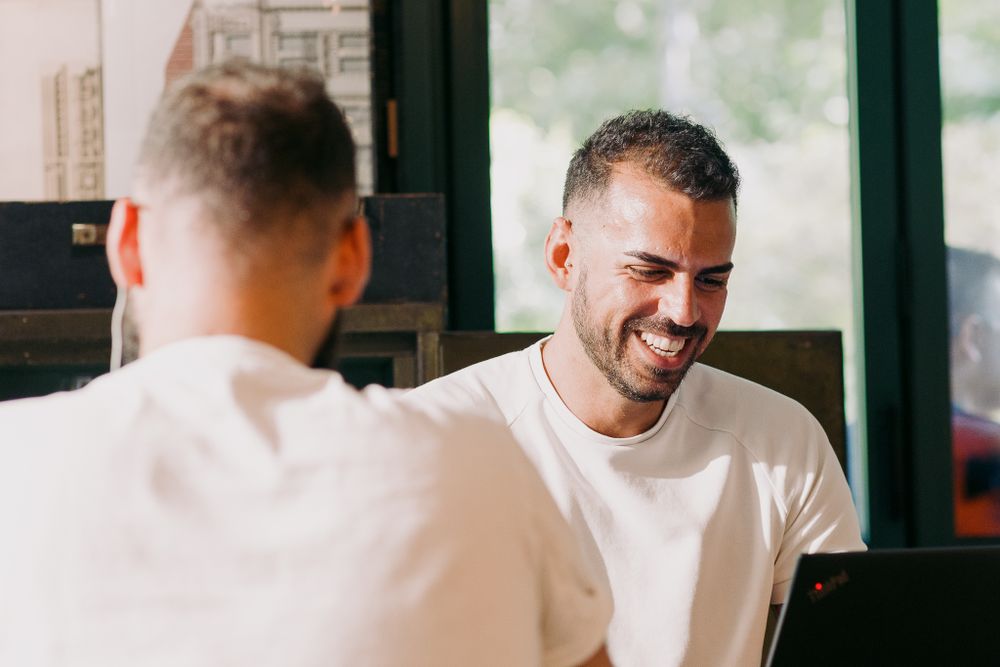 People sharing smiles and conversations in a casual dining environment.