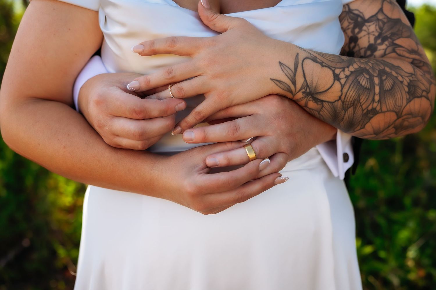 Romantic wedding couple sharing an intimate kiss near a rustic cabin in a grassy meadow.