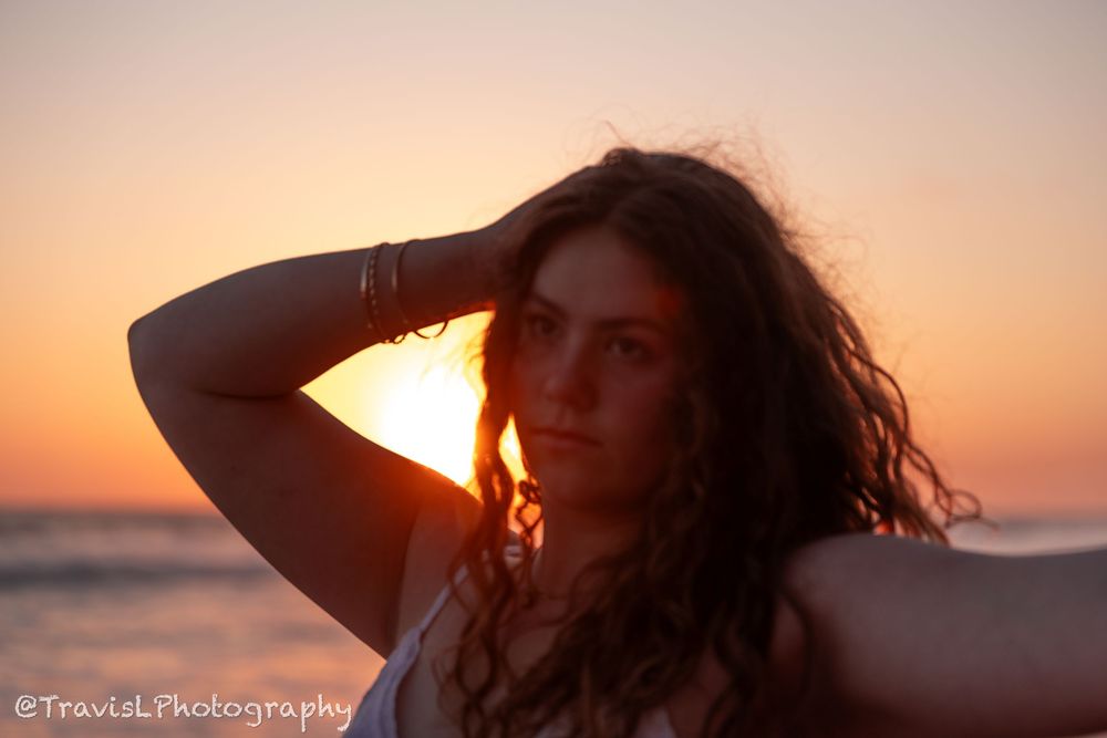 Warm-toned beach portraits at sunset with dramatic backlighting.