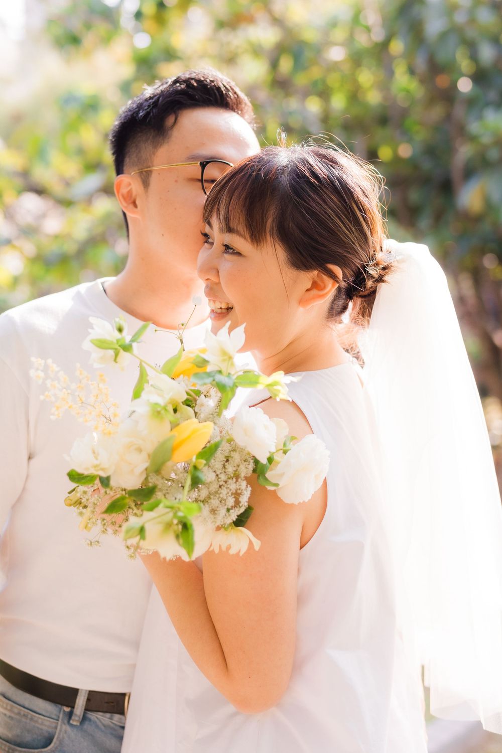 A joyful moment captured with white flowers and sunny garden backdrop.