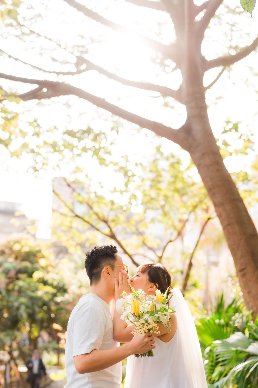 A romantic garden photoshoot with sunlight filtering through tree branches.