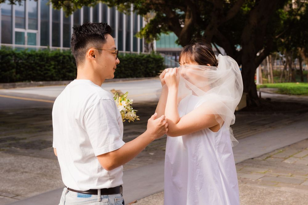 A sweet moment between a couple captured outdoors with yellow flowers.