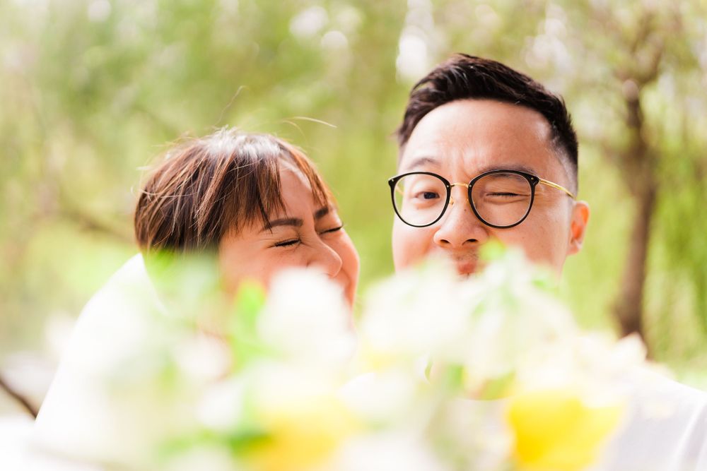 A joyful moment captured through blooming flowers in a garden setting.
