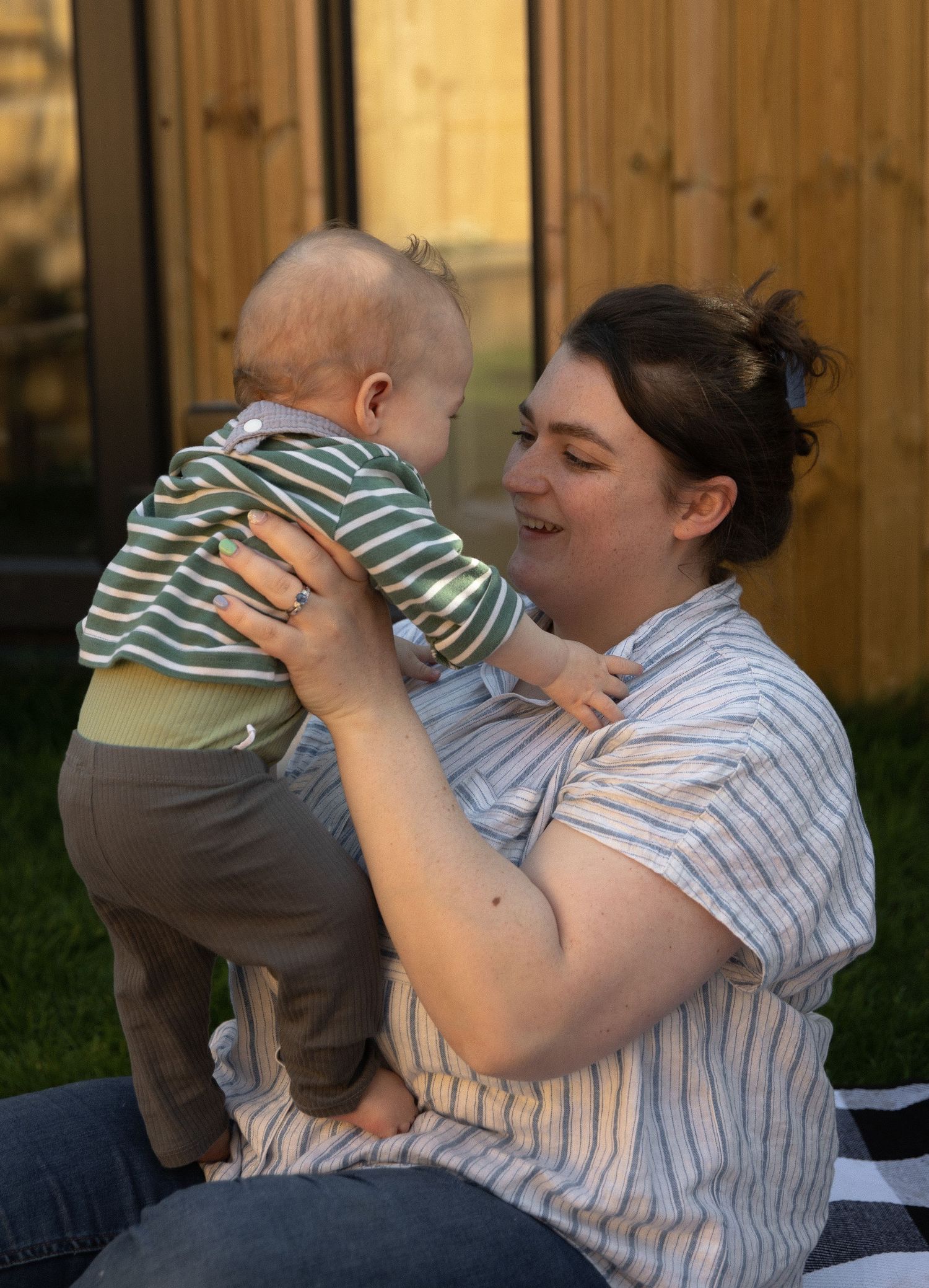Series of photos showing a tender moment on a sunny patio as someone lifts and embraces a small child.