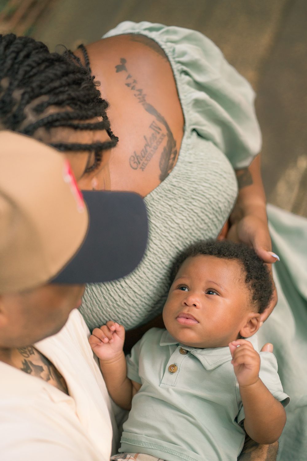 An intimate close-up of a young child lying down while being lovingly watched over.