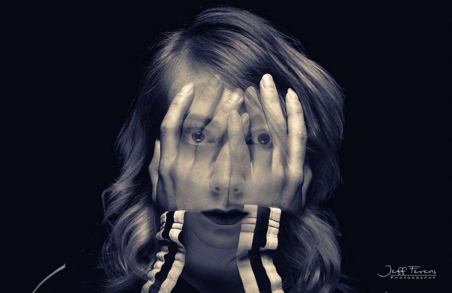 Double exposure of a woman looking through her hands