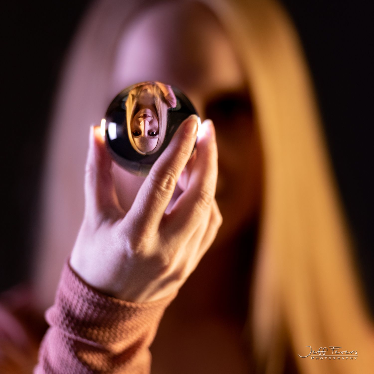Portrait of woman with long blond hair in crystal ball.