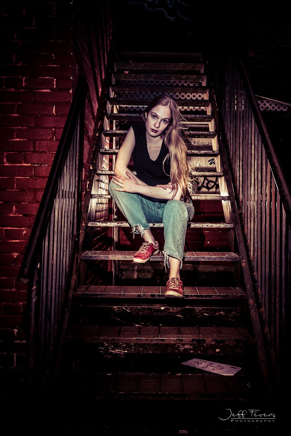 Grunge style portrait of a woman on a set of stairs