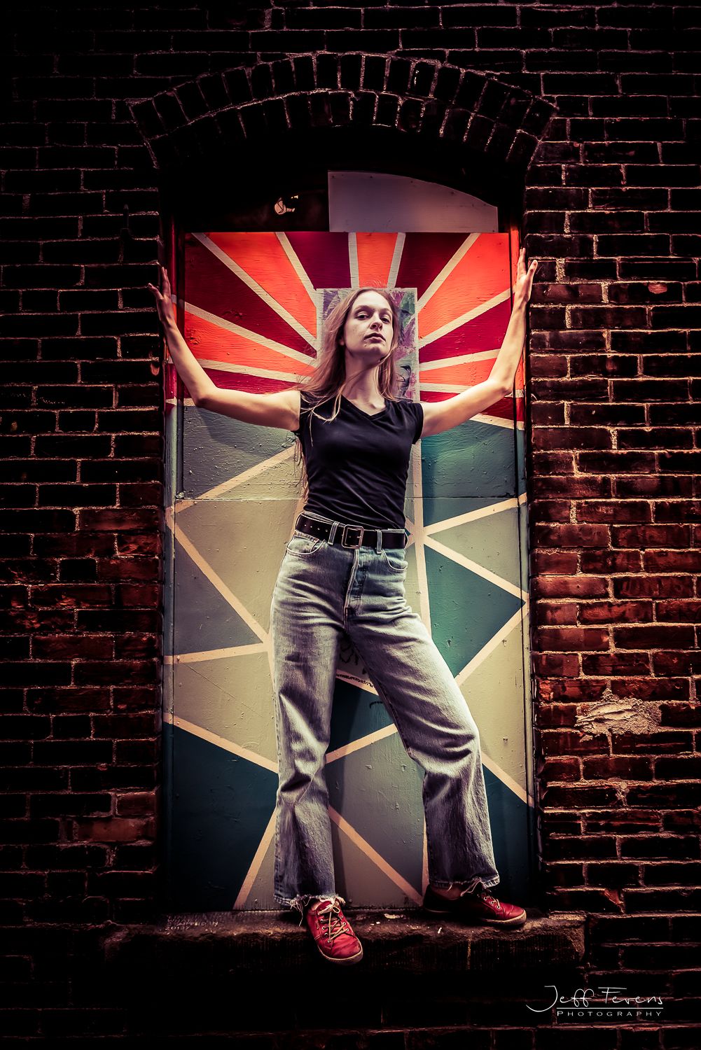 Grunge style portrait of a woman in front of a painted window.