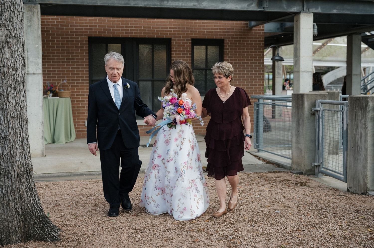 Small group walking together outdoors during a wedding ceremony.