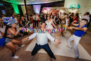 Wedding reception dance party with colorful ribbon limbo game.