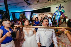 Wedding party celebrating with colorful decorations and unique performance art.