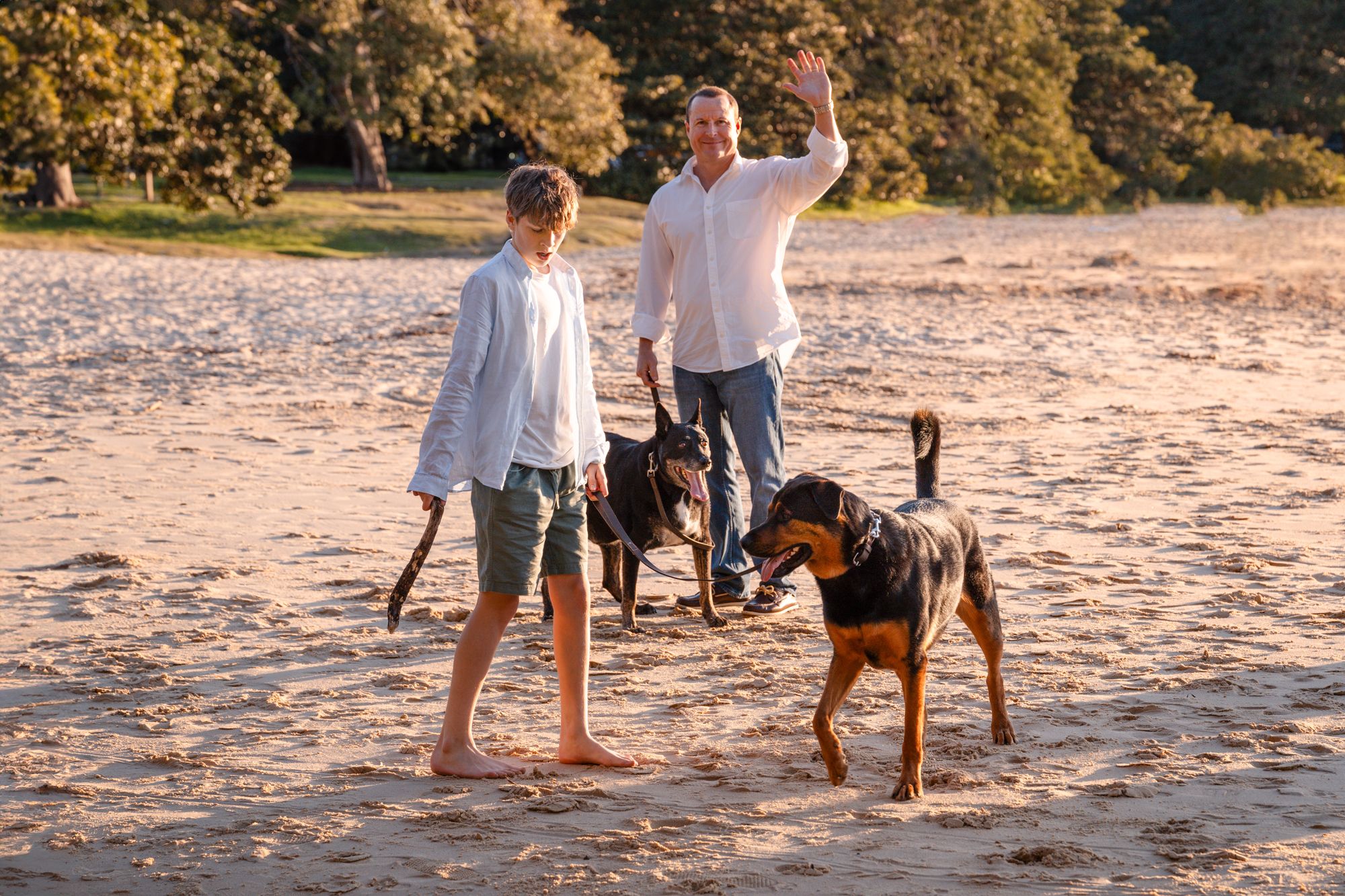 candid photo of dad and son with their dog in Mosman