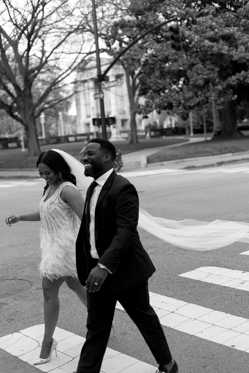 Newlyweds walk the streets of downtown Raleigh after their courthouse elopement.