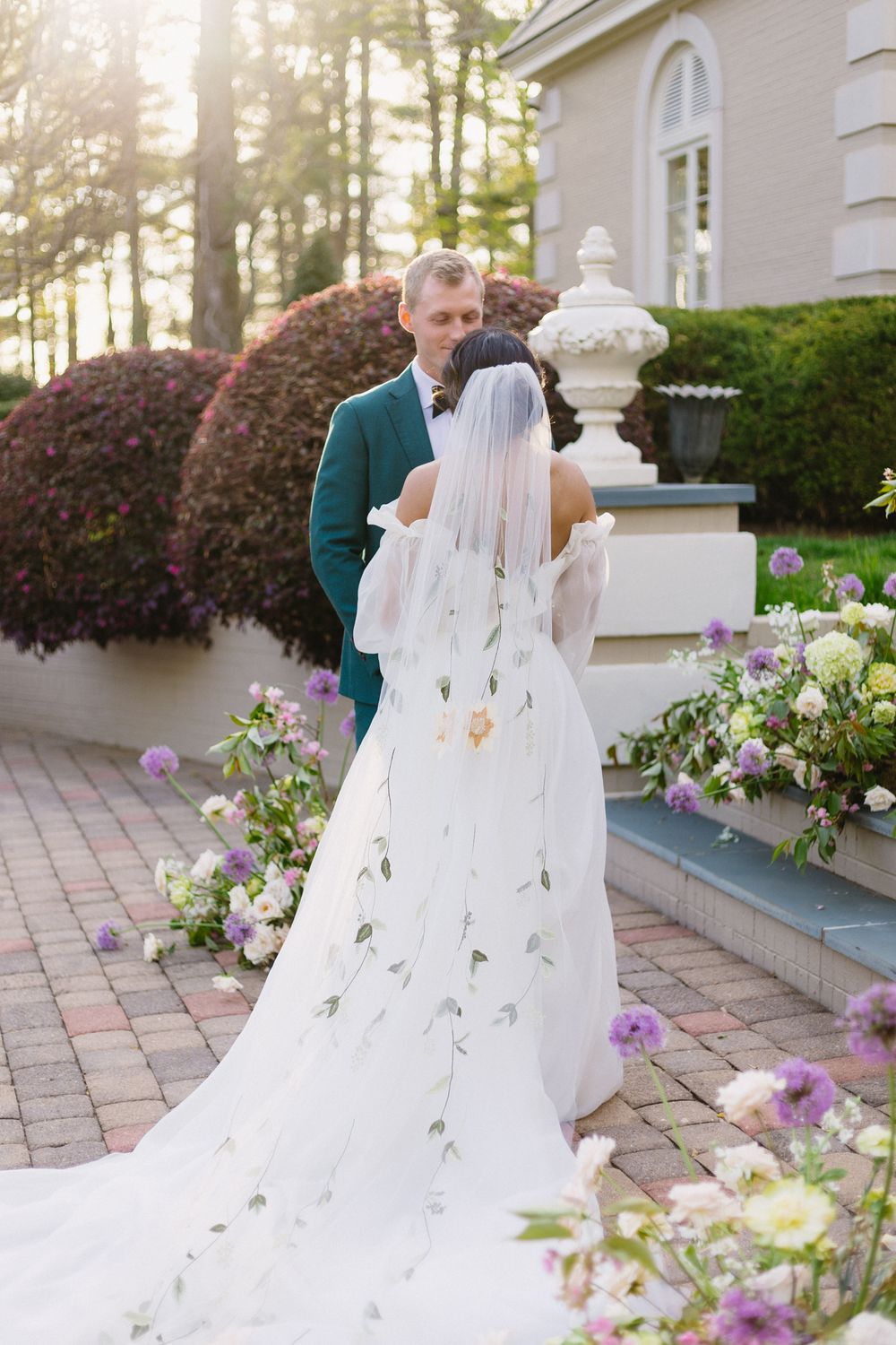 A bride and groom hold hands during their wedding ceremony.