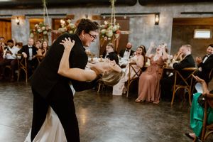A groom dips his bride during their first dance as husband and wife at Overlook Barn.