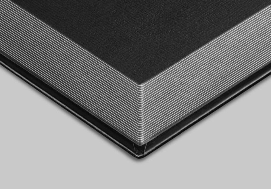 Blank 1/8" photo paper sheets stacked neatly, ready for printing